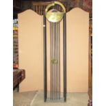 A Bauhaus style floorstanding clock with stepped circular brass dial and ebonised tubular steel