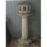 A good quality partially weathered cast contemporary three sectional bird table of octagonal form