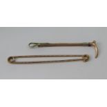 Two 9ct stock pins to include an example in the form of a riding crop, maker 'A&W', 8.6g total (2)