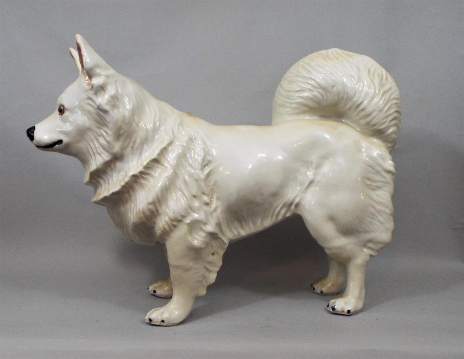 Ceramic figure of a hound with glass eyes, in standing position, 35 cm height