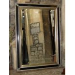Two contemporary reproduction wall mirrors of rectangular form with moulded frames and bevelled edge