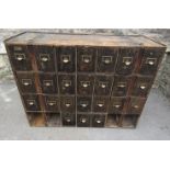 A vintage pine framed flight/bank of sheet tin lined filing drawers, 24 present, 3 missing, 112 cm