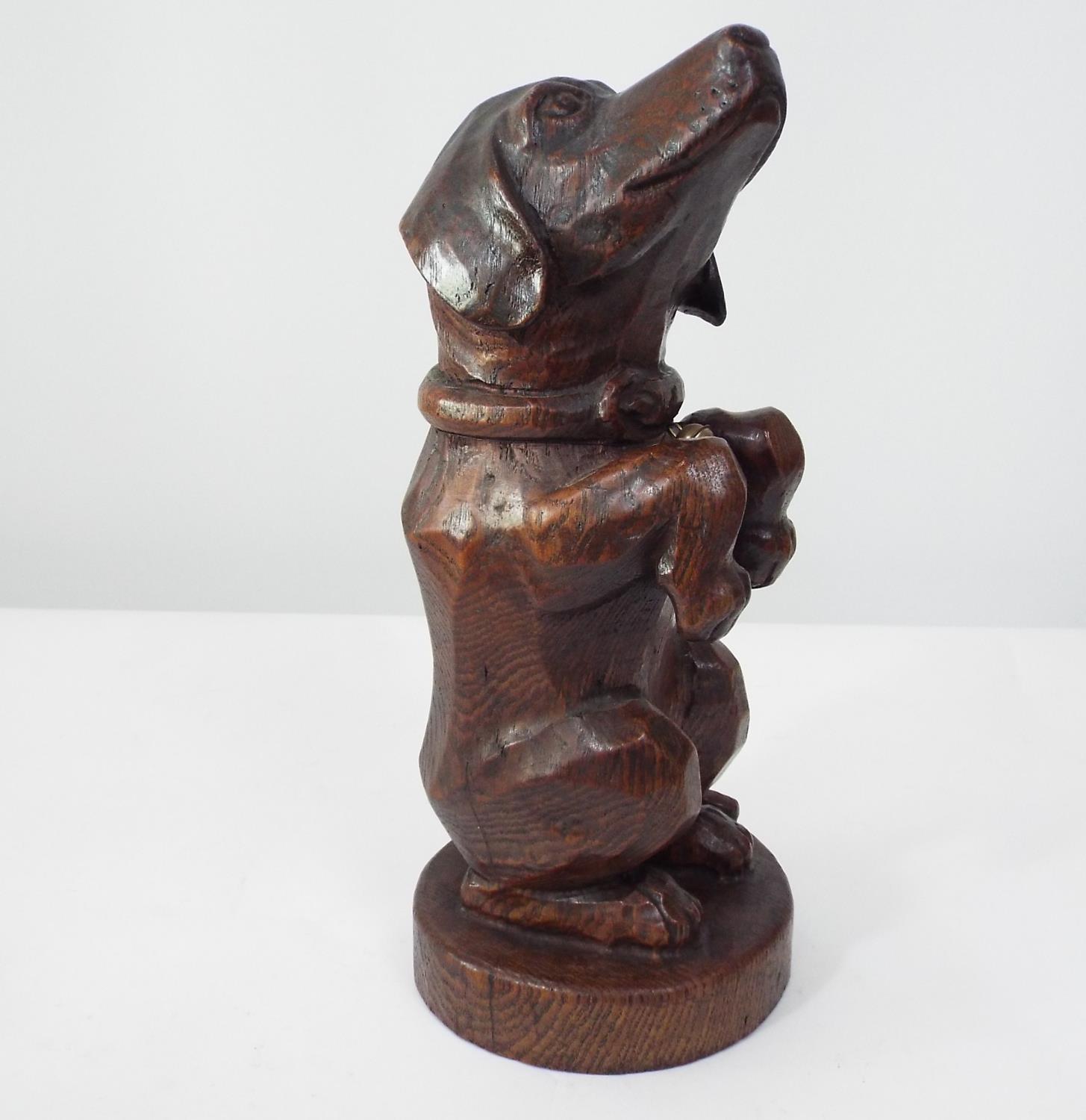 A late 19th century carved oak figure of a Dachshund in begging pose, 31cm high