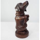 A late 19th century carved oak figure of a Dachshund in begging pose, 31cm high