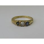 Three stone sapphire and diamond ring in yellow metal, size K, 3g (one blue stone paste replacement)