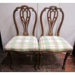 Good pair of continental walnut dining chairs, scrolled backs, stuff-over seats and sabre acanthus