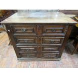 An early 18th century oak Countrymade chest of four long drawers, disguised as eight short, with