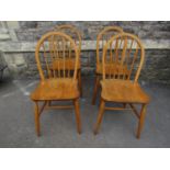 A set of four vintage Ercol light elm and beechwood hoop and stick back kitchen chairs raised on