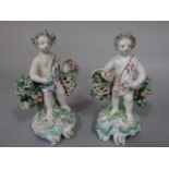A pair of late 18th century ceramics figures of cherubs holding flower baskets, in the Bow manner,