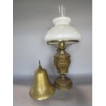 Cast metal baluster oil lamp, with gilt scrolled metal base decorated with foliage and masks, 50cm