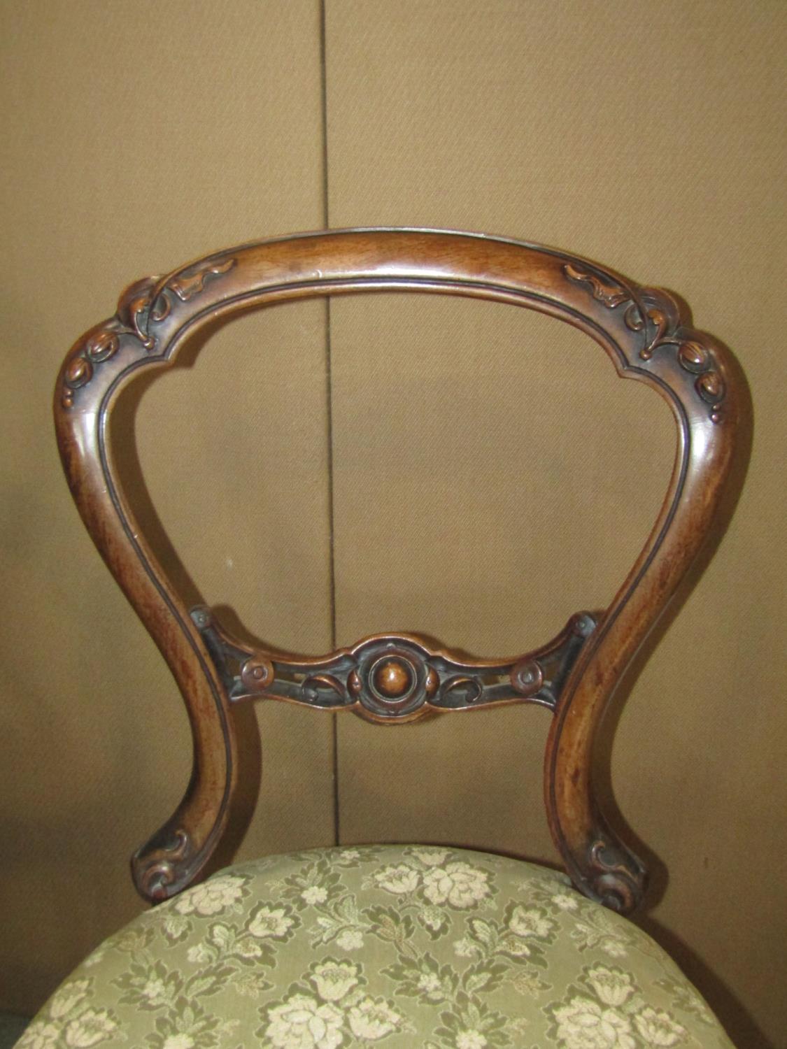 A pair of Victorian walnut balloon back dining chairs with carved foliate detail, serpentine - Image 3 of 3