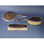 Matched three piece silver and tortoiseshell dressing set comprising mirror and two brushes (3)