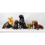 Five models of various dogs in ceramic and brass including a Labrador by Beswick no 2314, two