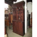 A 19th century simulated rosewood library bookcase, the upper section with moulded dentil balustrade