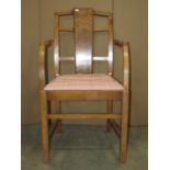 An Art Deco walnut open elbow chair with drop in upholstered seat raised on square cut supports