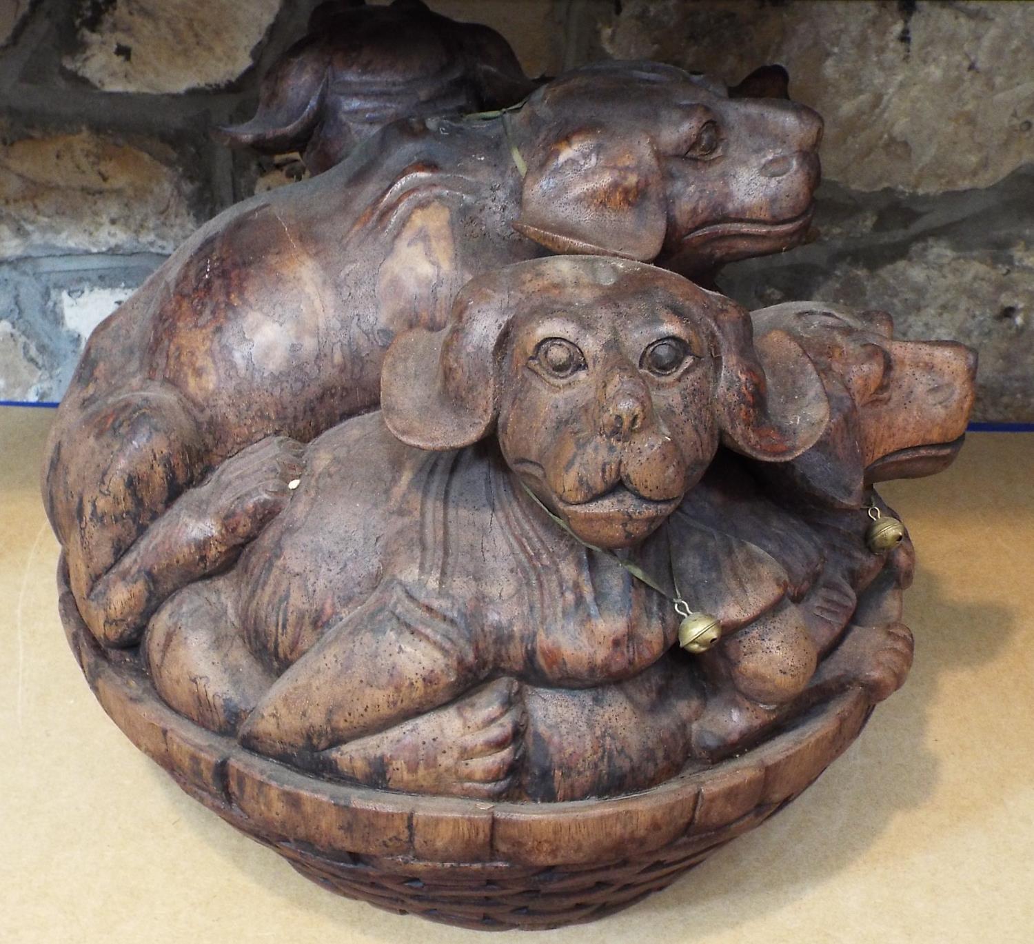 Solid carved hardwood group, five puppies in a basket, 40 cm in height