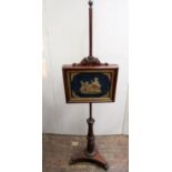 A 19th century mahogany face screen raised on a tricorn base enclosing an adjustable panel two