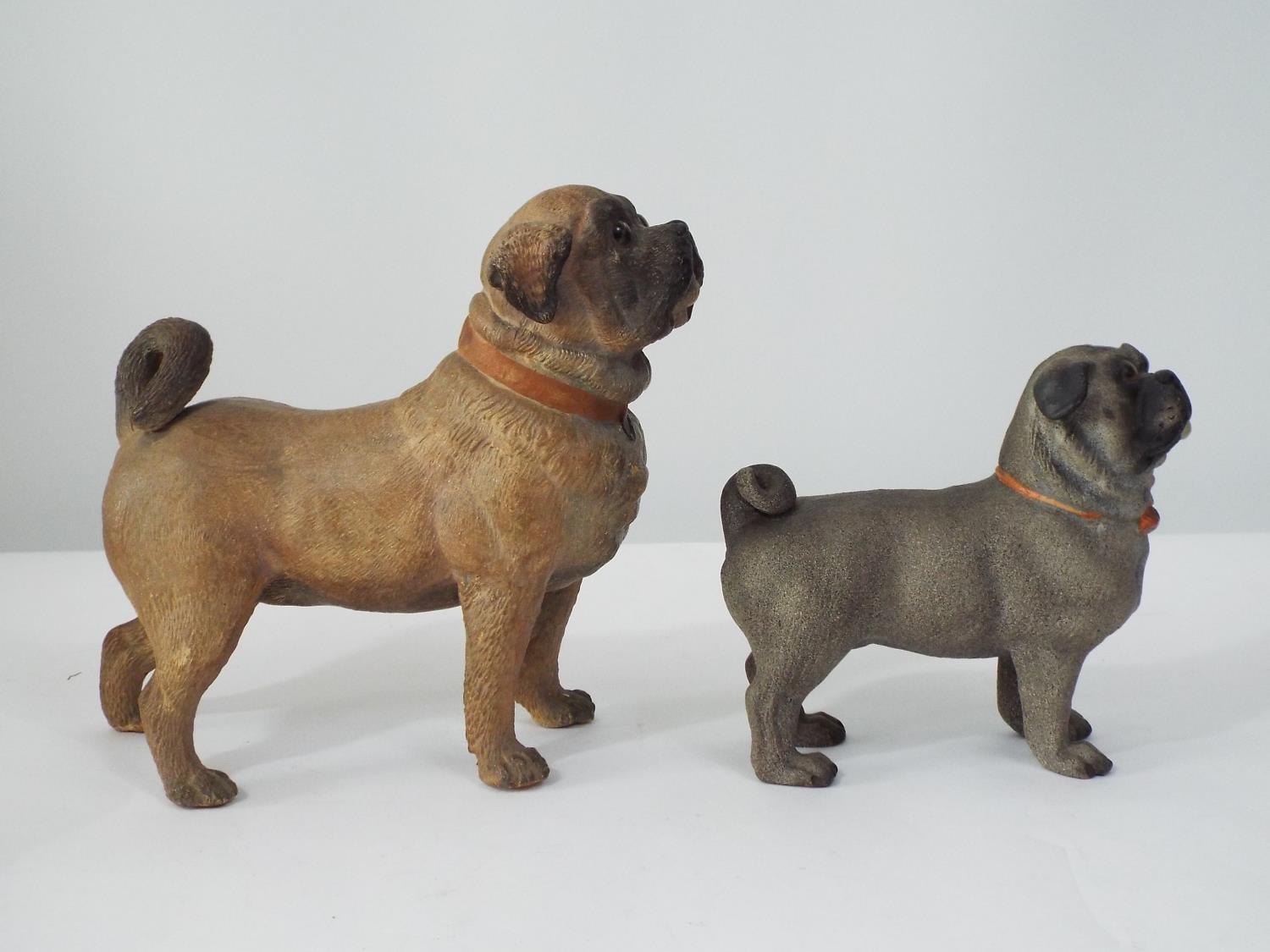 A late 19th century terracotta figure of a standing Pug, together with a smaller similar model, 18cm