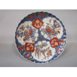 A 19th century oriental charger with shaped rim and painted and gilded imari type decoration