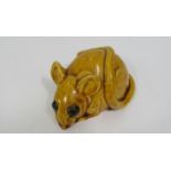 A pottery figure of a field mouse in mustard coloured glaze, 9 cm maximum