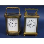 An oval brass cased carriage clock, together with a further square example, both 11.5cm high (2)