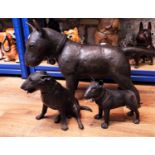 A bronze life size figure of an Old English Bull Terrier and two further smaller examples, 50cm high