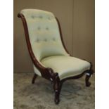 A Victorian nursing chair with serpentine upholstered seat and button back within a mahogany