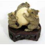 Meiji Period - Ivory Okimono of three rats rolling an egg, raised on a carved hardwood base, 7cm