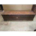 A vintage long narrow and shallow stained pine box with hinged lid, exposed dovetail construction