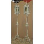 A pair of gothic style iron work green painted standard lamps with hexagonal glazed lanterns, rope