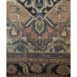 Afghan rug with central blue medallion upon a fawn ground, 180 x 130cm