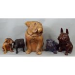 A carved hardwood model of a bulldog, two further carved timber models of bulldogs, a further bronze
