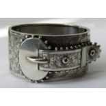 Aesthetic movement hinged silver bangle in the form of a buckled belt, with engraved decoration