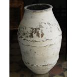 An old terracotta olive type jar with simple twisted banded detail painted and distressed 70 cm high