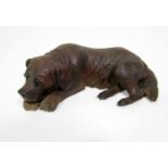 Late 19th century Austrian carved timber study of a resting hound, 18cm