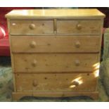 A Victorian stripped pine bedroom chest of three long and two short drawers beneath a later