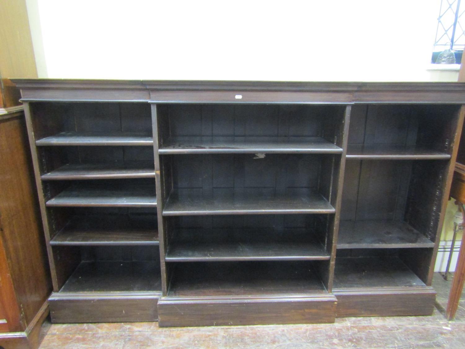 An Edwardian breakfront open bookcase, in three section, enclosing adjustable shelves, 190cm wide