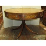 A Georgian style drum table, the circular top enclosing four real and four dummy drawers, brass ring