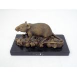 A bronze figure of a rat climbing on top of knotted bags (probably representing money) raised on a