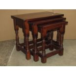 A Jaycee oak nest of three occasional tables in the old English style together with a Victorian