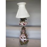 Good quality cameo glass baluster oil lamp, with applied white on cranberry, with gilt cast metal