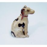 Primitive pottery hand painted figure of a seated hound in a Staffordshire style, 9 cm in height