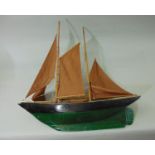 Pond hand built timber yacht, two masts, solid keel hull painted green and black, length 70cm