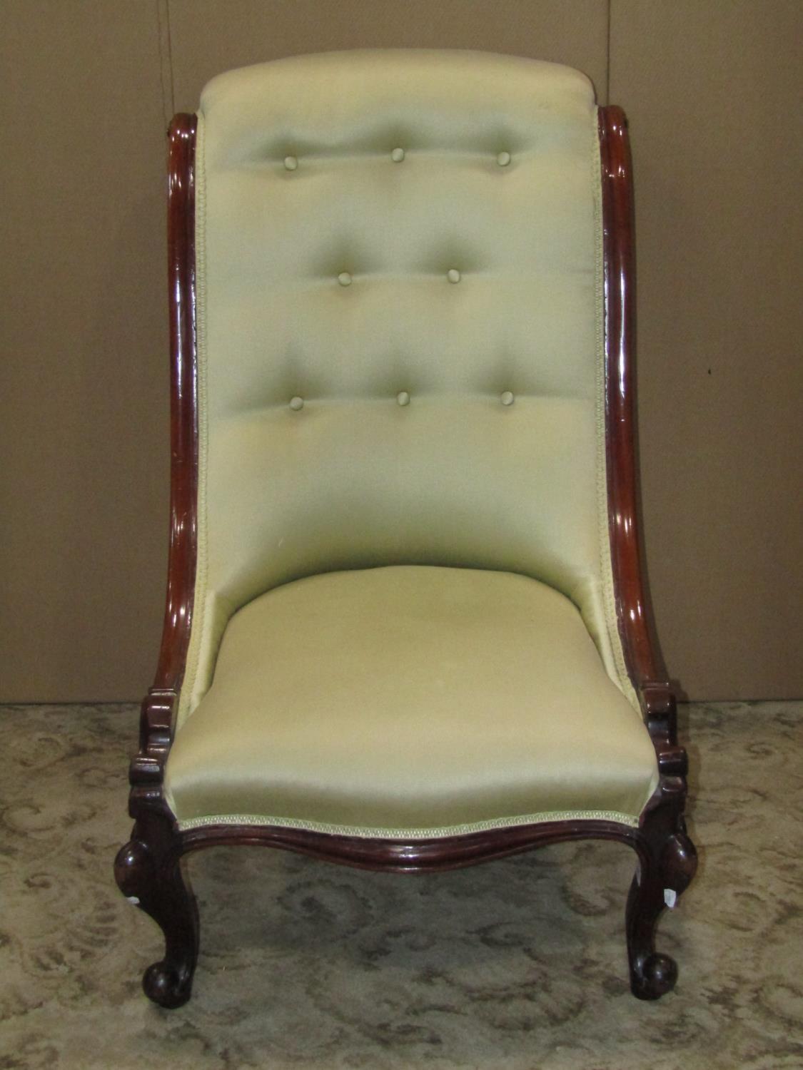 A Victorian nursing chair with serpentine upholstered seat and button back within a mahogany - Image 2 of 2