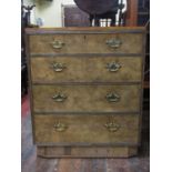 An art deco walnut and figured walnut chest of four long drawers on a shaped base with brass plate