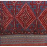 Kelim runner with geometric medallion decoration upon a navy blue ground, 260 x 60cm