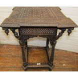 A small 19th century Indian hardwood, two tier occasional table, with turret corners, raised on