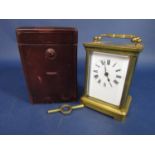 A brass cased carriage clock, the back engraved with a standing lion, 11cm high in a Morocco leather