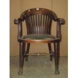 An early 20th century mahogany office chair, the horseshoe shaped and slatted back with scrolled