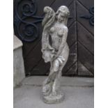A weathered cast composition stone garden figure in the form of a standing maiden holding a